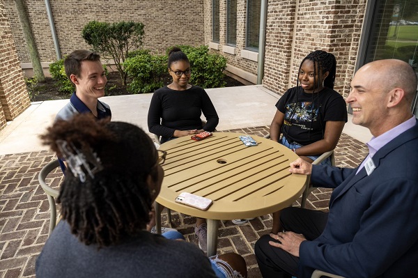 Students and Provost Around Library Porch Table